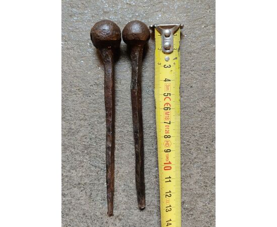 Two huge wrought and embossed iron nails, 17th-18th century