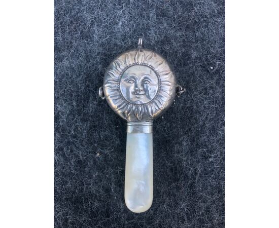 Silver rattle for children depicting the sun. Mother of pearl handle. England.     