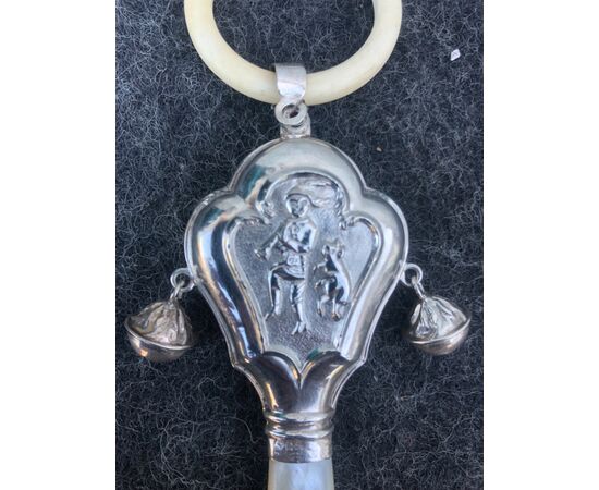 Silver baby rattle depicting a pied piper. Mother-of-pearl handle. Europe.     