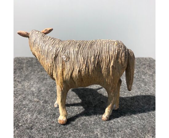 Crib sculpture depicting a sheep in polychrome wood and glass eyes.Italy     