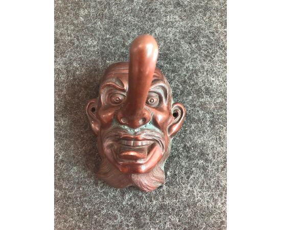 Small mask with a grotesque copper figure.Japan     