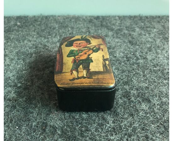 Papier mache snuffbox depicting a scene painted with a jester with guitar.Europa     