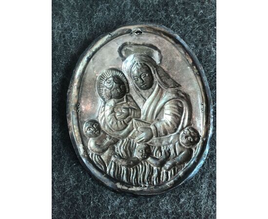 Silver tabard plaque depicting Madonna with Child and purgative souls. Brotherhood of souls. Genoa     