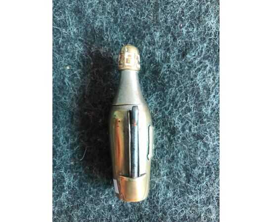 Brass matchbox in the shape of a champagne bottle (Veuve Cliquot) with a cigar-cutter. France     