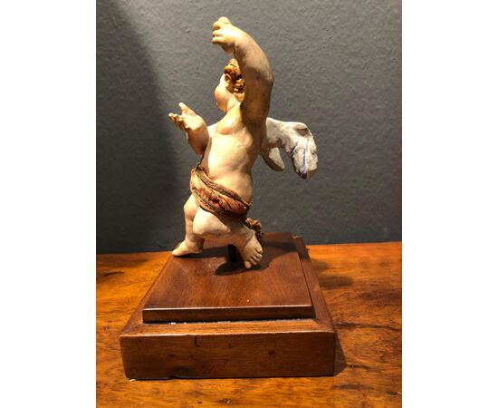 Small terracotta sculpture depicting an angel.     
