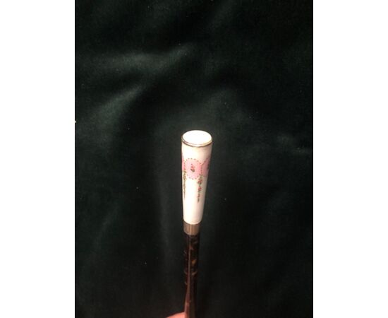 Evening stick with enameled silver knob with floral decorations and part of the tortoise barrel.     