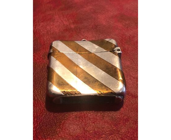 Silver matchbox with geometric striped decoration.England.     