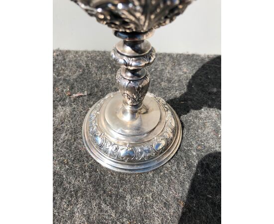 Embossed silver cup with stylized plant motifs and shield with a noble coat of arms.     