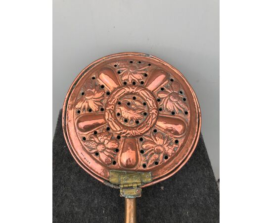 Embossed copper warmer with flowers and birds decoration.Wooden handle.     