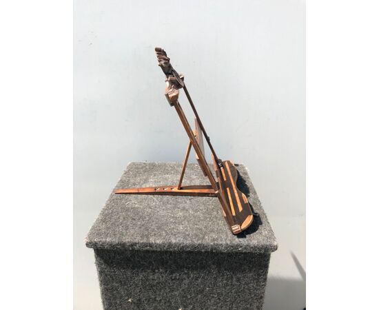 Adjustable music stand from sheet music with ribbon motifs and instruments.     