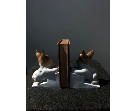 Pair of porcelain bookends depicting dogs.     