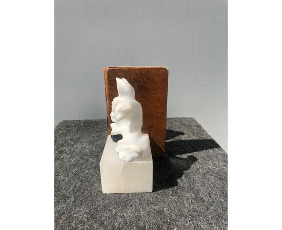 Pair of alabaster bookends depicting dogs with ball.     