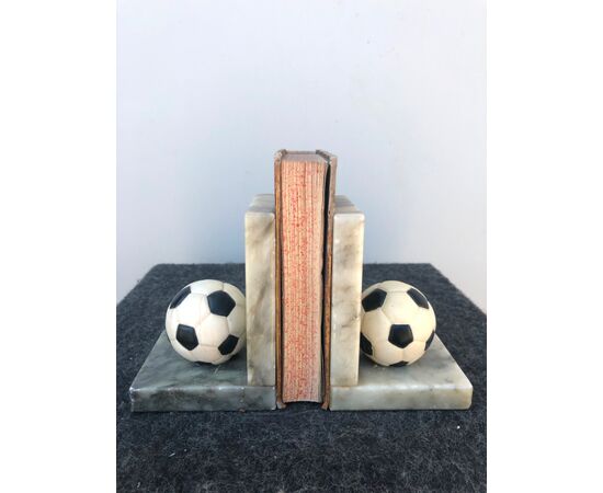 Pair of marble bookends with soccer ball.     