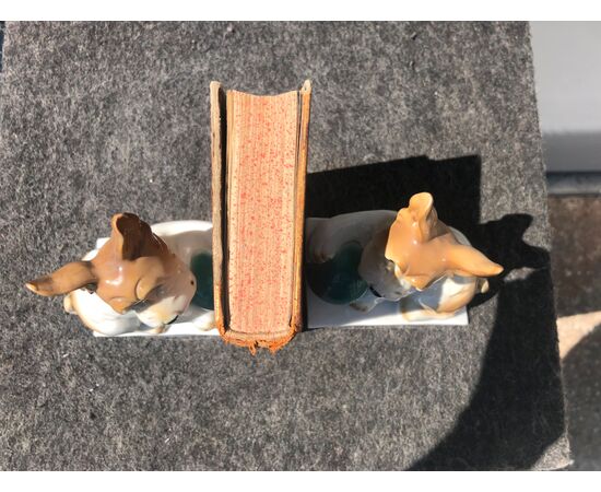 Pair of porcelain bookends depicting dogs.     