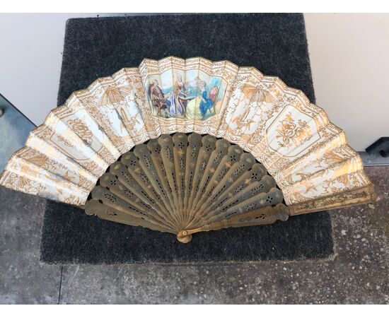 Perforated and gilded tortoise fan with paper bunting with watercolor prints with gallant scenes.     