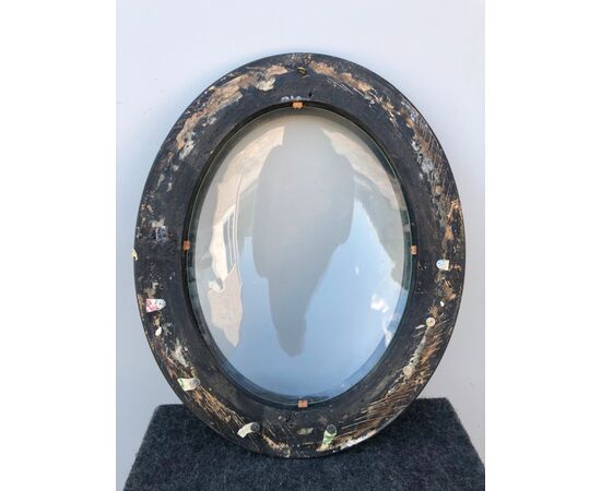Frame in carved and ebonized wood with convex glass.     