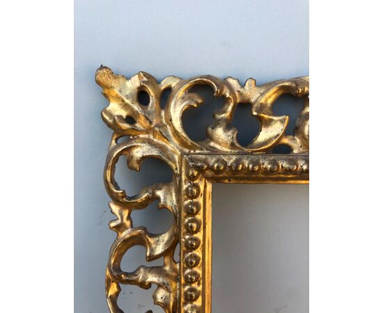 Carved wood, perforated and gold leaf foil frame, Florence.     