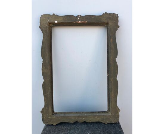 Carved and gilded wooden frame with stylized art-nouveau plant motifs.     