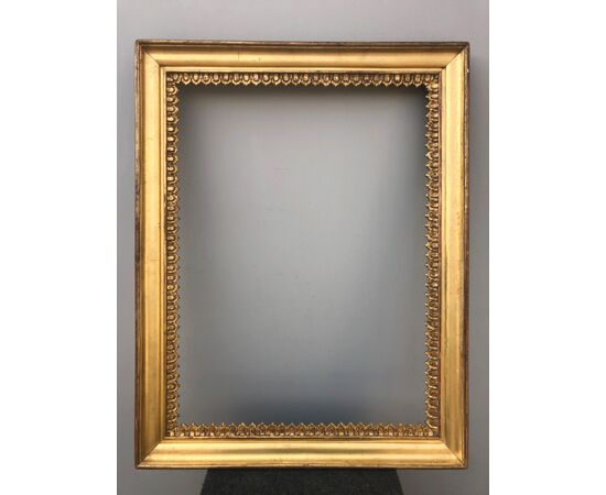 Pair of carved wooden frames and gold leaf with stylized plant motifs.     