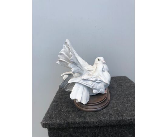 Pair of doves in bisque porcelain on a wooden base.Signed.     