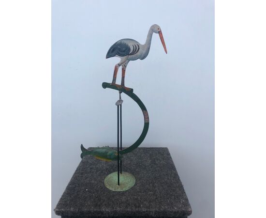 Gioco in metallo dipinto raffigurante  uccello con pesce contrappeso, basculante su base.