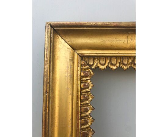 Pair of carved wooden frames and gold leaf with stylized plant motifs.     
