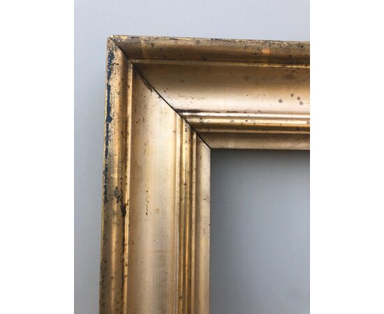 Frame in carved wood and gold leaf.     