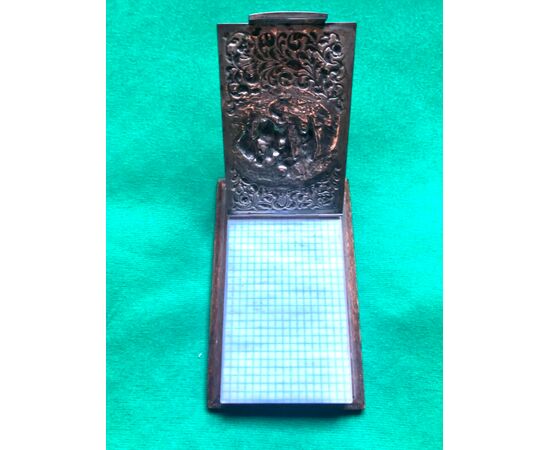 Notepad holder in rosewood and embossed silver with village scene and plant motifs. Holland.     