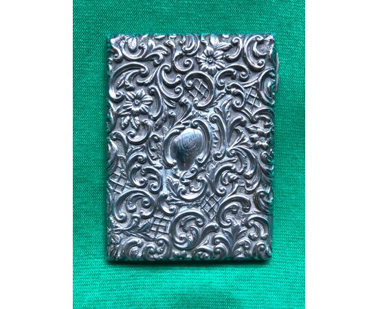 Embossed silver ticket holder with plant and rocaille motifs and inscription with date: Maud 1912. England.     