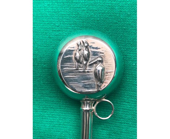 Silver baby rattle with lake scene and herons.     