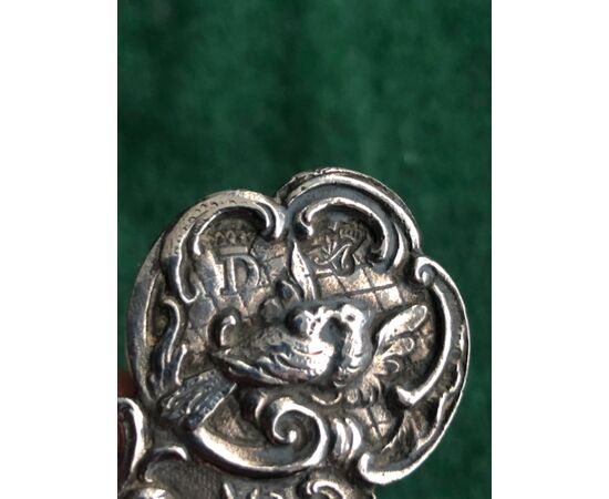 Colino da te’ in argento con 4 putti,uccellini,motivi floreali e rocaille.