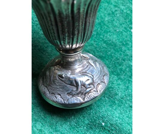 Sugar spreader in embossed silver with scenes of musician cherubs, vegetable and animal elements with rocaille borders.     