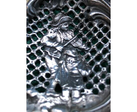Spoon in perforated silver with rocaille motifs, musicians, putto and ship.     