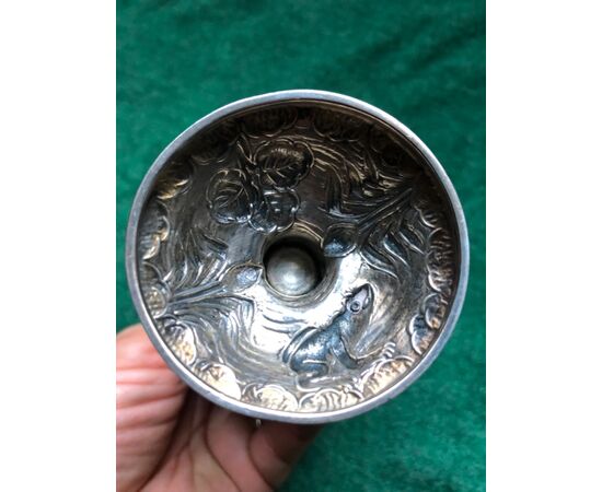 Sugar spreader in embossed silver with scenes of musician cherubs, vegetable and animal elements with rocaille borders.     
