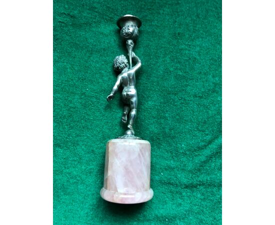 Silver candlestick with rose quartz base depicting a naked boy holding the candle holder Italy.     