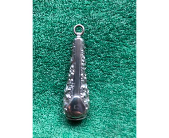 Silver cigar cutter with floral decoration.     