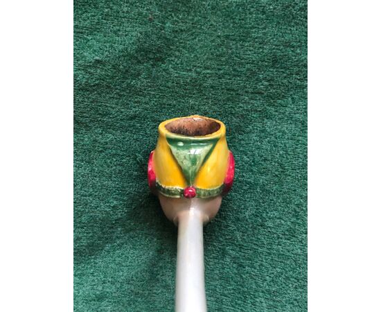 Earthenware pipe painted with the figure of a jester.     