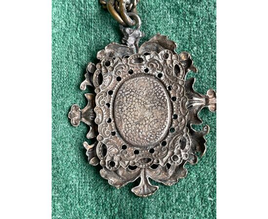 Silver-plated and perforated metal medal with rocaille plant motifs and three towers symbol of San Marino.     