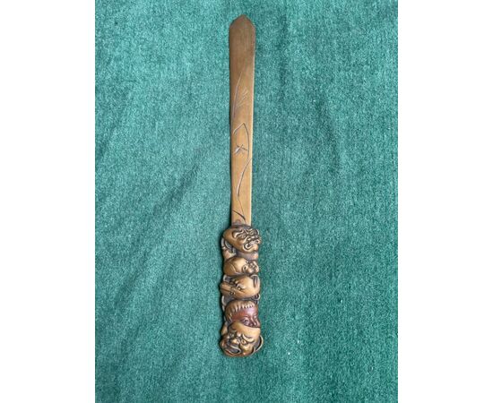 Brass letter opener with engraved naturalistic motifs and handle with masks from the commedia dell&#39;arte. Japan.     