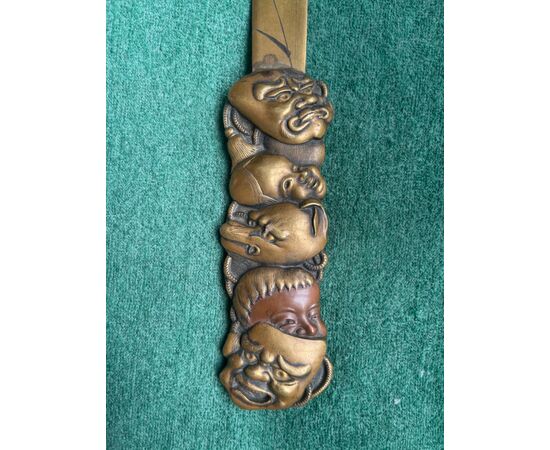 Brass letter opener with engraved naturalistic motifs and handle with masks from the commedia dell&#39;arte. Japan.     