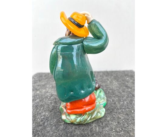 Glass sculpture depicting a seated character with a flask of wine, Bohemia.     