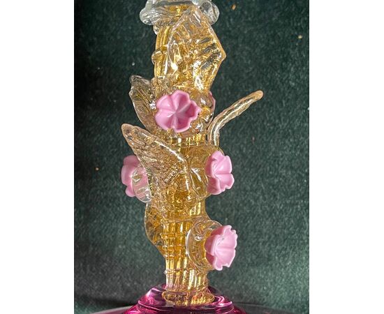 Iridescent glass with gold leaf and floral applications.Signed on the base.Murano.     