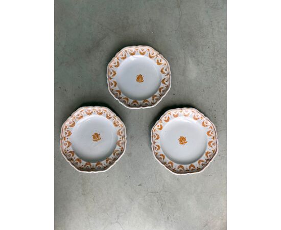 Three plates decorated with festoons and flowers.Moustiers, France.Signed     
