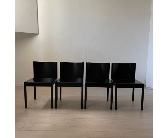 Group of four black wooden chairs     