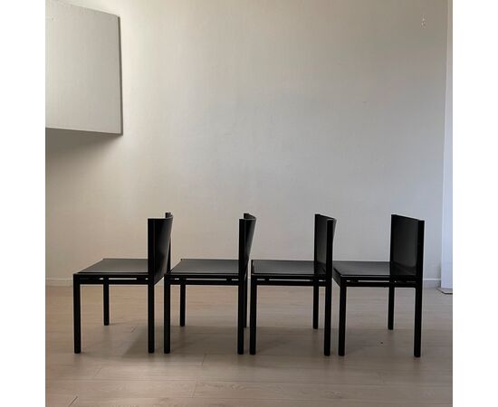 Group of four black wooden chairs     