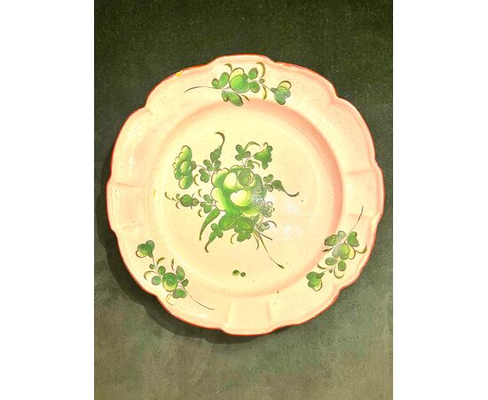 Majolica plate with green decoration with floral motifs.Strasbourg. France     