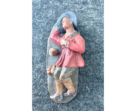 Terracotta nativity scene sculpture depicting a sleeping popular figure.     