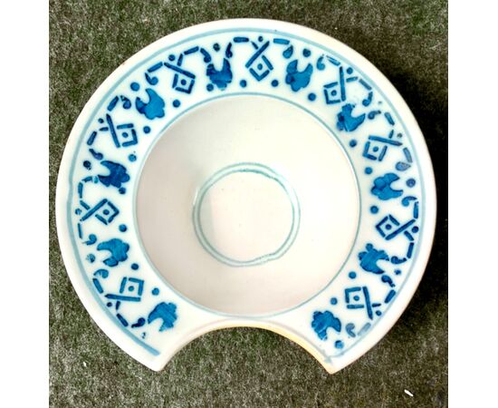 Round plate in blue monochrome majolica with geometric motifs on the brim. France.     