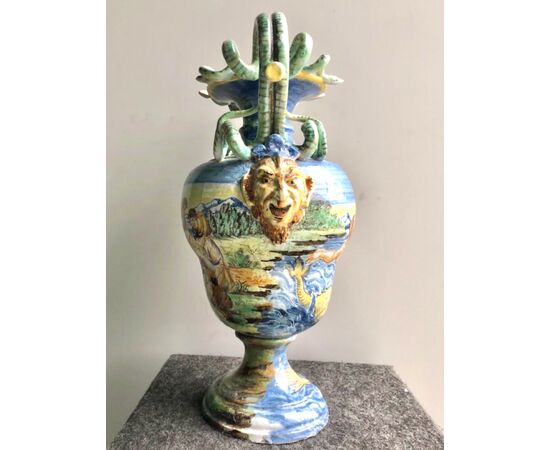 Large majolica vase with serpentine-shaped handles with historiated decoration with bacchanal.Manufactured by Angelo Minghetti .Bologna.     