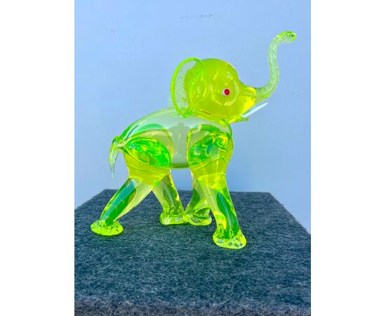 Elephant in heavy yellow &#39;uranium&#39; glass with red eyes and milky tusks.Seguso manufacture, Murano.     